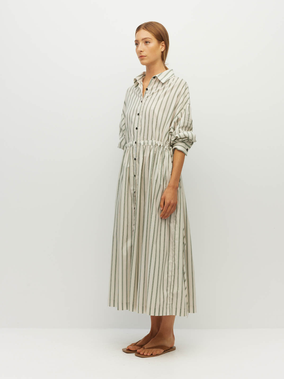 Juliette Hogan Lenora Dress (Batch Stripe Cotton) Pine Line - striped cotton shirtdress with shirt collar, full-length button sleeves, and drop waist with tie detail.