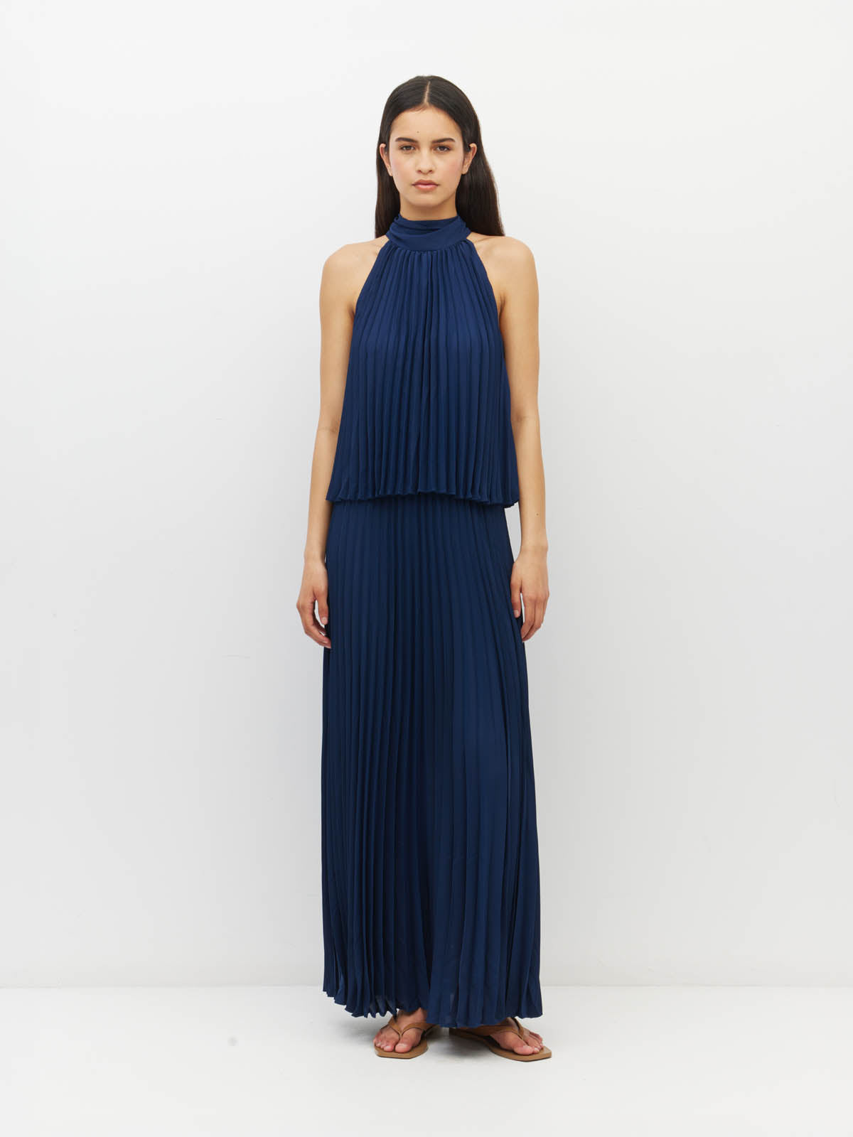 Juliette Hogan Amira Dress (Matte Pleat) Navy - pleated event dress with high tie neckline, elasticated waist, and ankle-length hem.