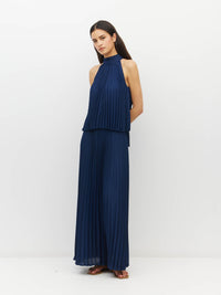 Juliette Hogan Amira Dress (Matte Pleat) Navy - pleated event dress with high tie neckline, elasticated waist, and ankle-length hem.