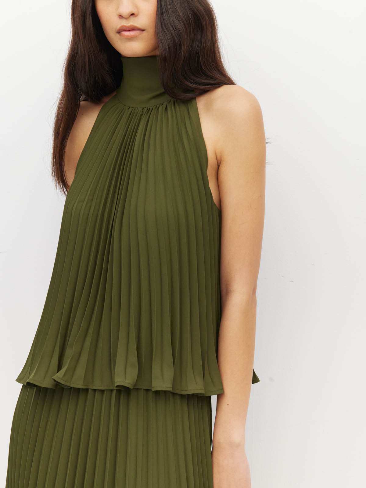 Juliette Hogan Amira Dress (Matte Pleat) Olive - pleated event dress with high tie neckline, elasticated waist, and ankle-length hem.