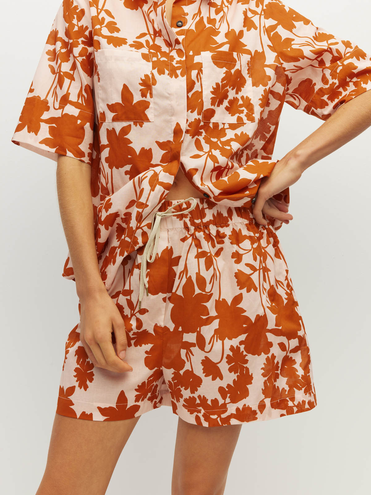 Juliette Hogan Robin Short (Shadow Floral Cotton) Clay - elasticated printed cotton shorts with drawcord waist and side seam pockets, mid-thigh length.